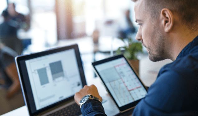 business-man-looking-analyzing-projects-his-laptop-computer-tablet 1